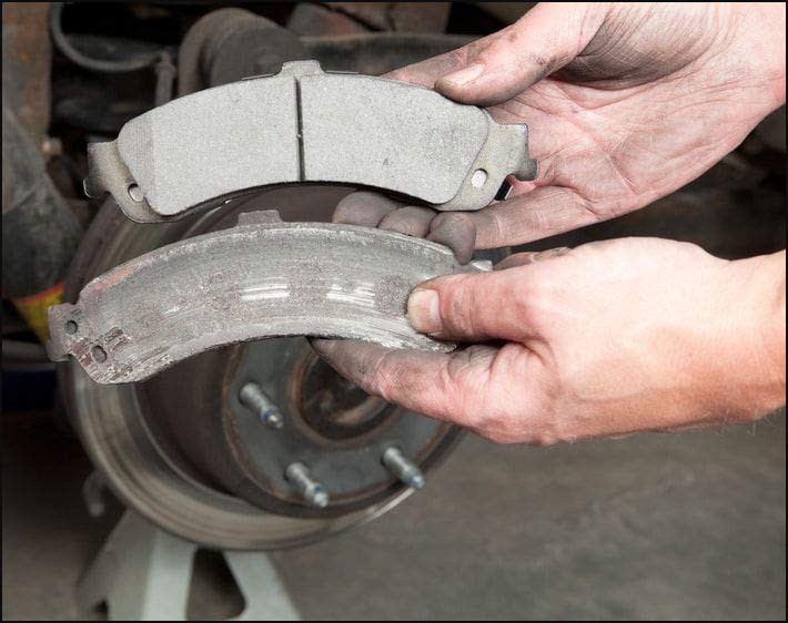 Worn brake pads (bottom) versus new pads (top)